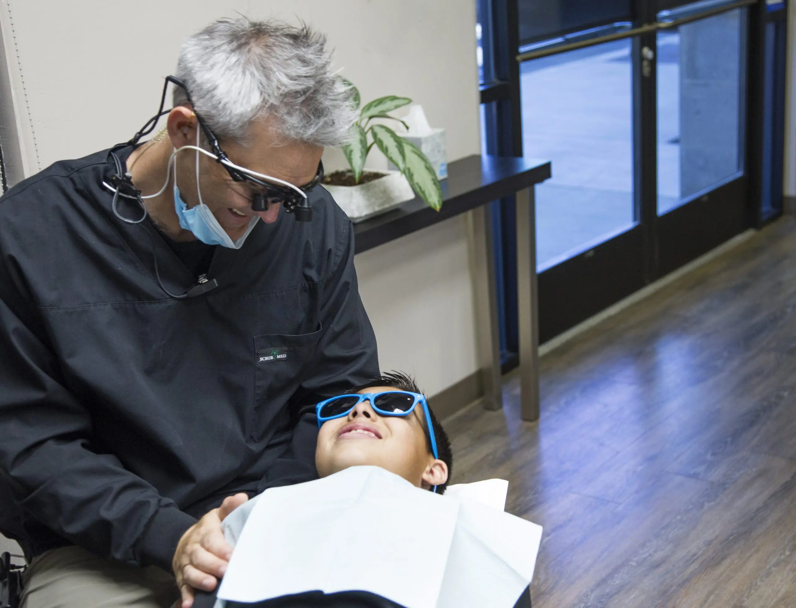 Dr. Jared R. Gianquinto providing orthodontic care to a young patient, represents Cost & Insurance Braces & Invisalign at Gianquinto Orthodontic Arts in Bakersfield, CA.