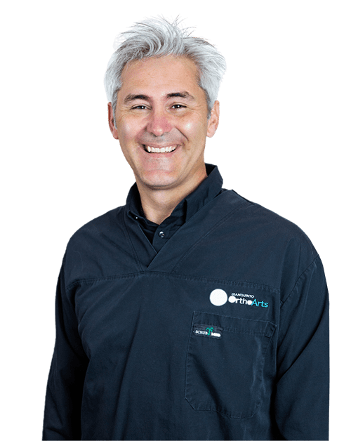 Dr. Jared R. Gianquinto, top-rated family orthodontist at Gianquinto Orthodontic Arts in Mammoth Lakes, CA, wearing a dark dental uniform with the College of the Arts logo.