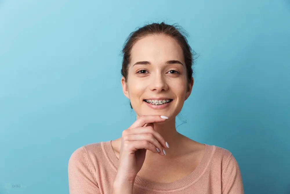 a woman smiling with braces after considering aligners vs braces in Bakersfield and Tehachapi, CA