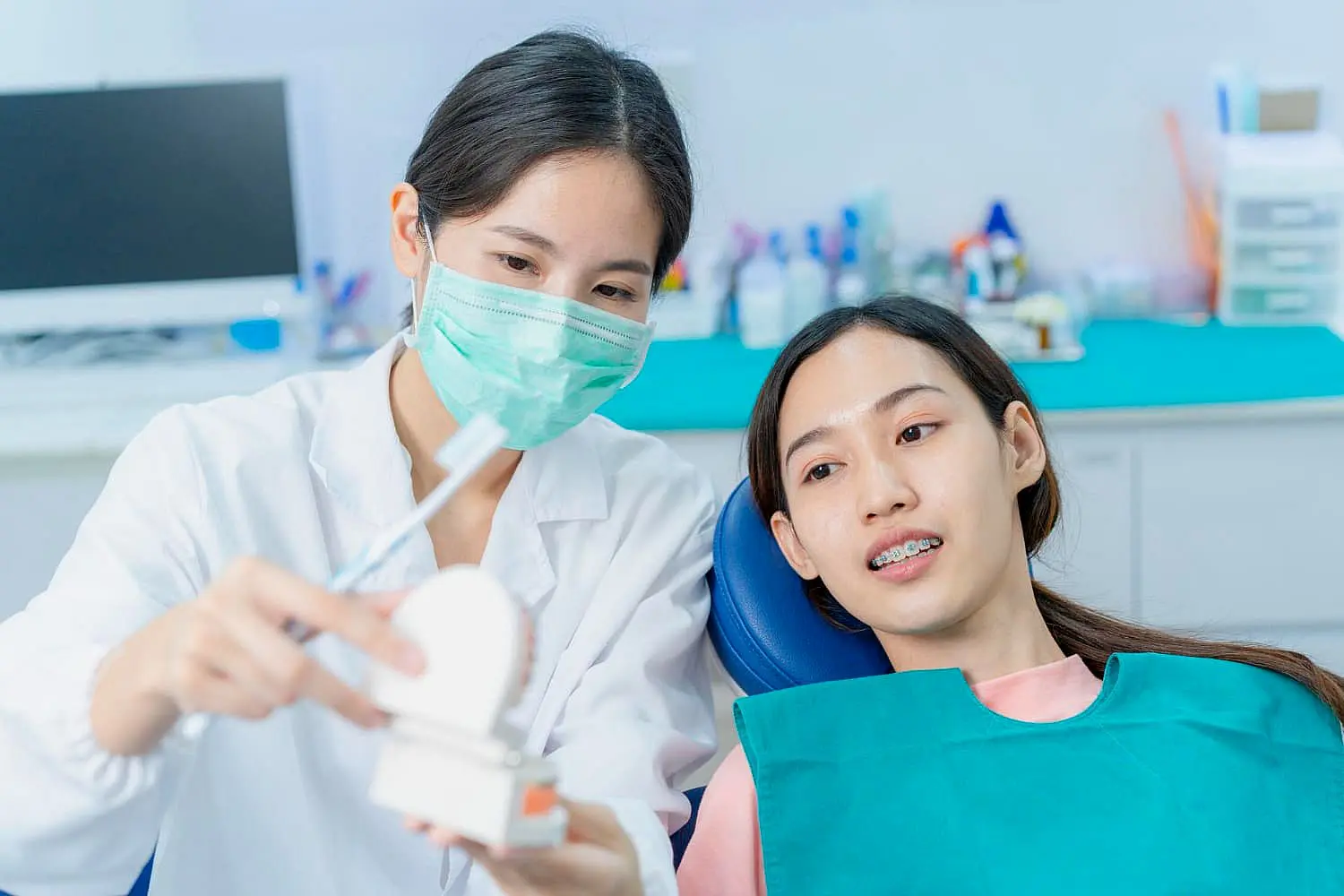 A masked dentist explains personalizing your metal braces experience at Gianquinto Orthodontic Arts in Bakersfield, Tehachapi or Mammoth Lakes, CA
