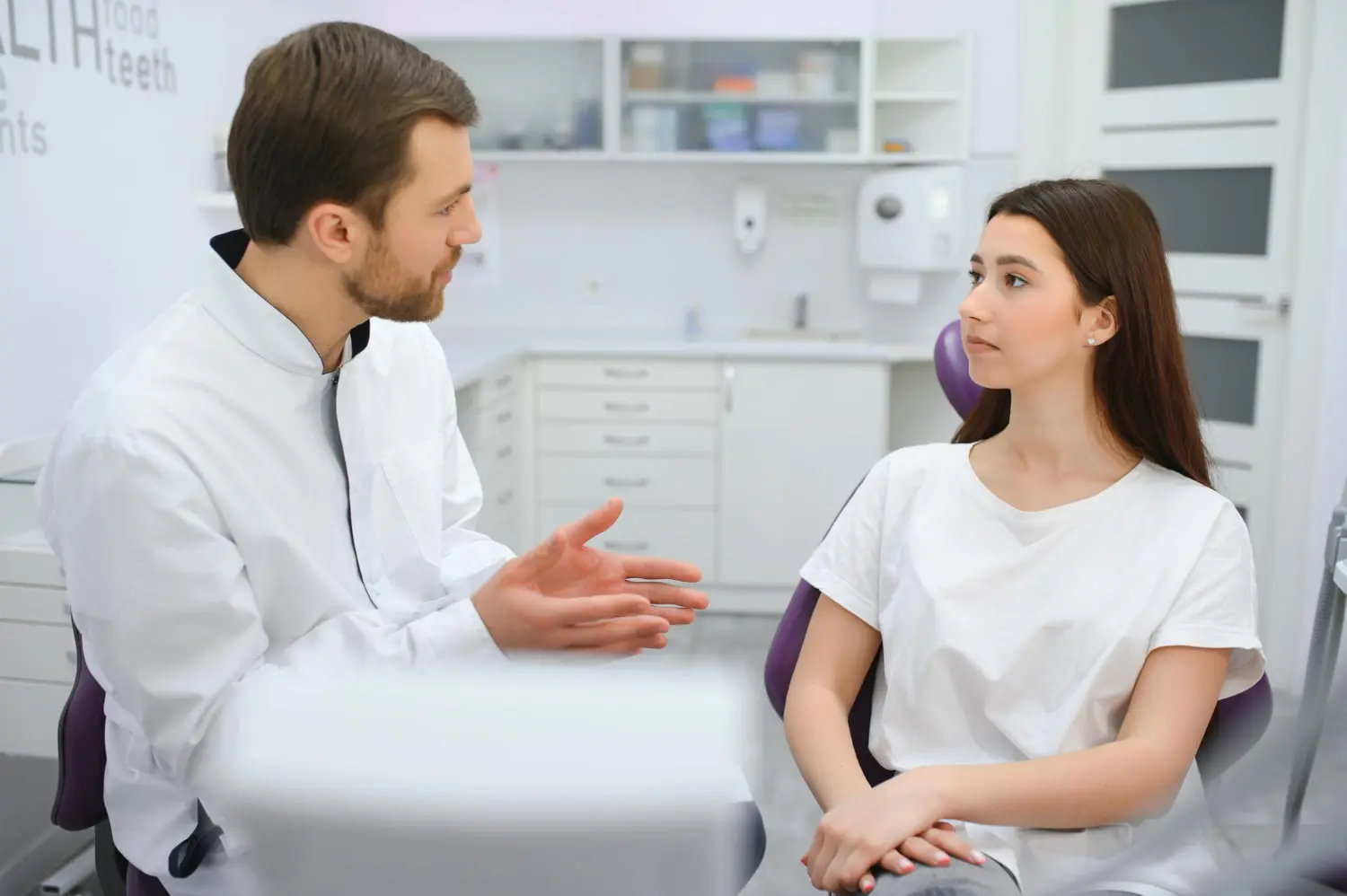 A dentist discusses Myofunctional Therapy for Tongue Thrust with a female patient at Gianquinto Orthodontic Arts in Bakersfield, Tehachapi or Mammoth Lakes, CA.