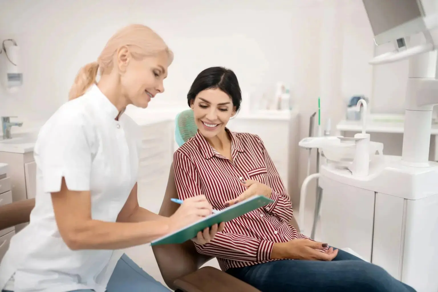 Dentist with patient discuss about dental insurance coverage at Gianquinto Orthodontic Arts in Bakersfield, Tehachapi or Mammoth Lakes, CA