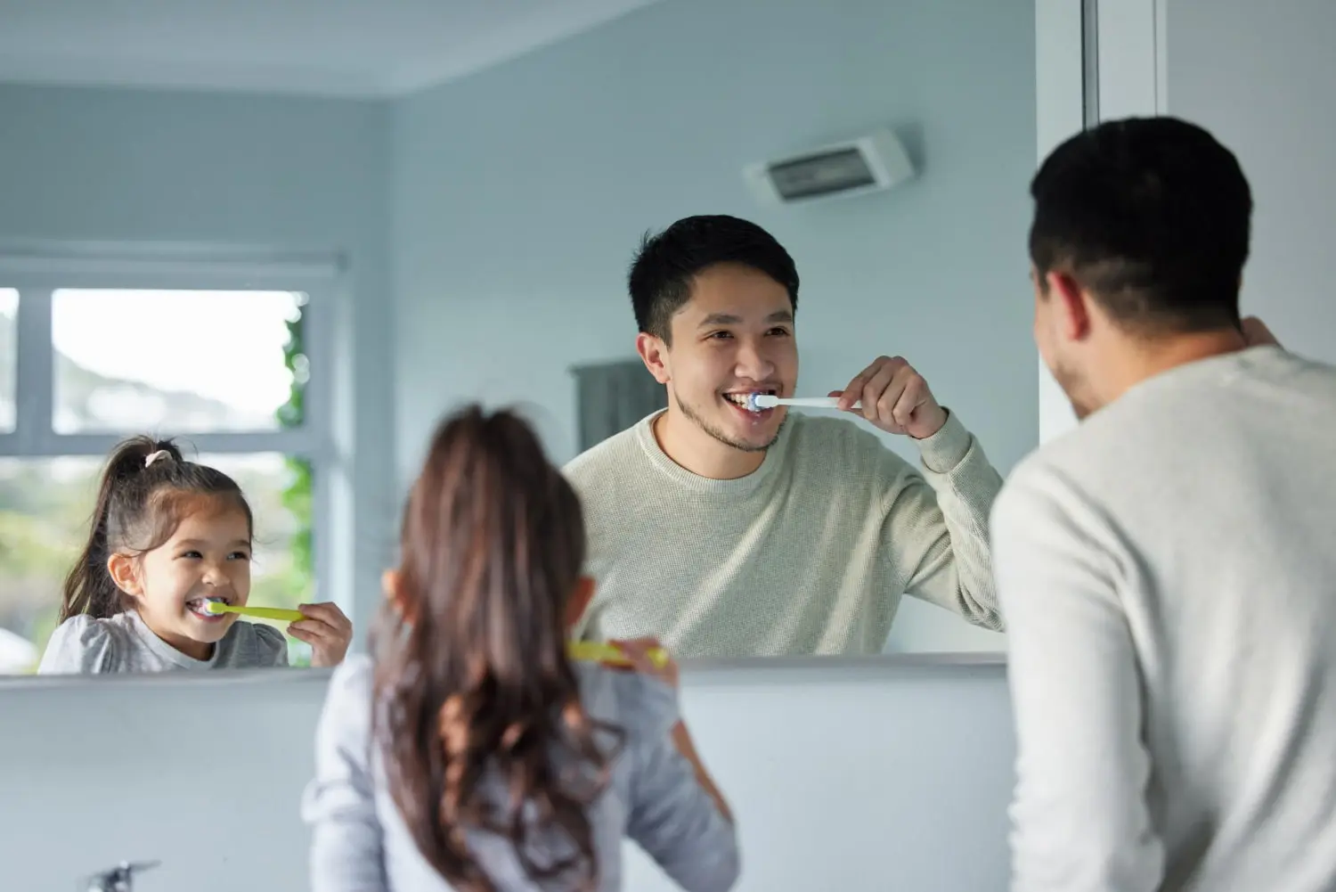 A man recovering from jaw surgery brush their teeth together at Gianquinto Orthodontic Arts in Bakersfield, Tehachapi or Mammoth Lakes, CA.