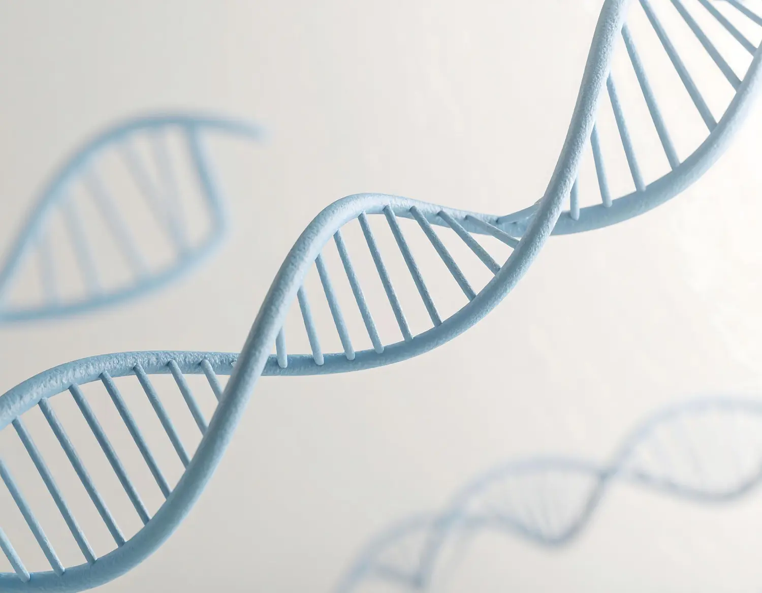 Blue DNA double helix model on light background, highlighting underbite genetics at Gianquinto Orthodontic Arts in Bakersfield, Tehachapi and Mammoth Lakes, CA.