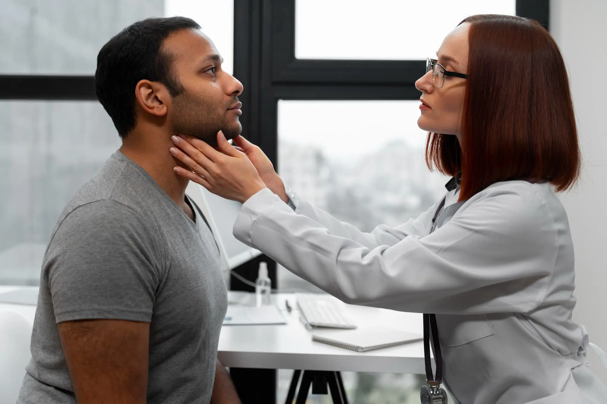A doctor examines a male patient’s neck for Physical therapy and rehabilitation after jaw surgery at Gianquinto Orthodontic Arts in Bakersfield, Tehachapi or Mammoth Lakes, CA.