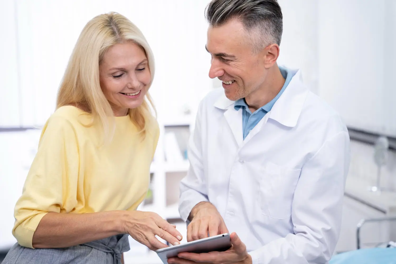 A doctor and woman smile while reviewing orthodontic insurance plans for braces at Gianquinto Orthodontic Arts in Bakersfield, Tehachapi or Mammoth Lakes, CA