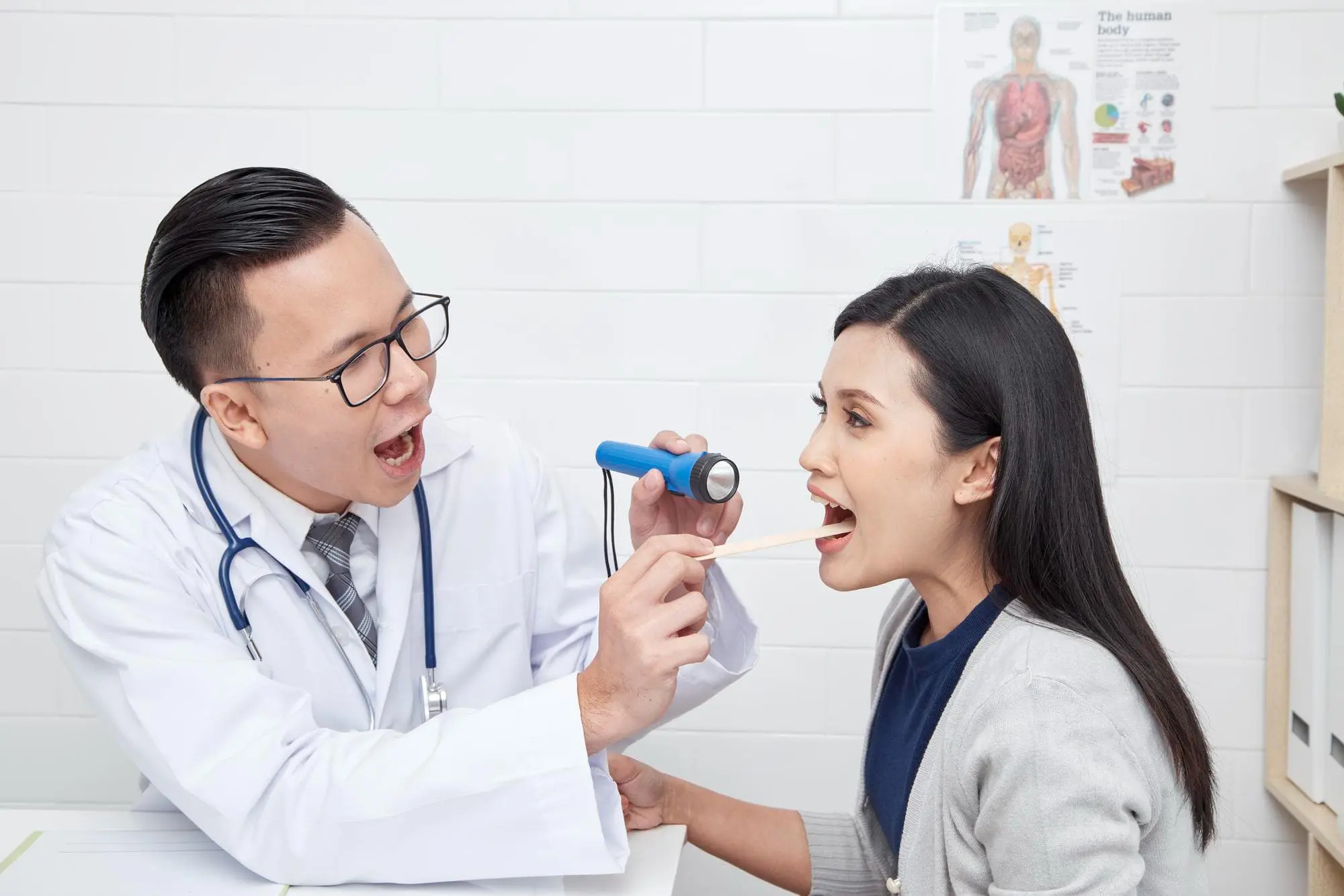 A doctor at Gianquinto Orthodontic Arts examines a woman's throat for tongue thrust treatmen in Bakersfield, Tehachapi or Mammoth Lakes, CA.