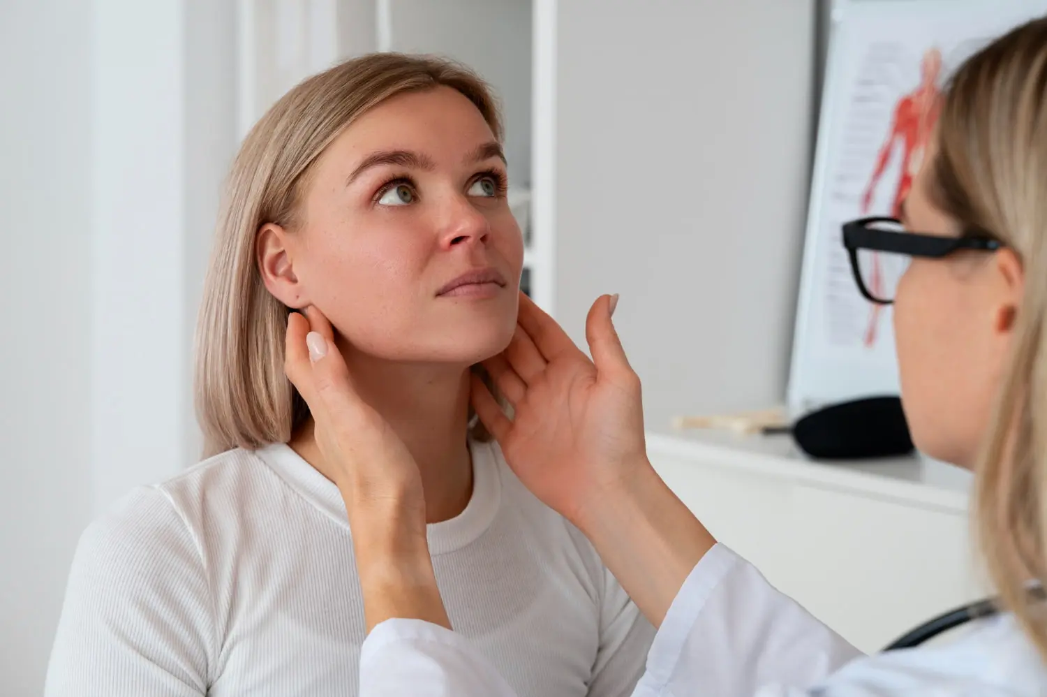 A doctor checks a woman's lymph nodes, underscoring jaw surgery role at Gianquinto Orthodontic Arts in Bakersfield, Tehachapi or Mammoth Lakes, CA.