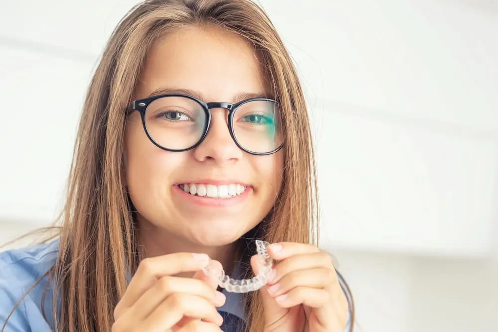 Smiling with a clear dental aligner from Children’s Orthodontist at Gianquinto Orthodontic Arts in Bakersfield, Tehachapi and Mammoth Lakes, CA.