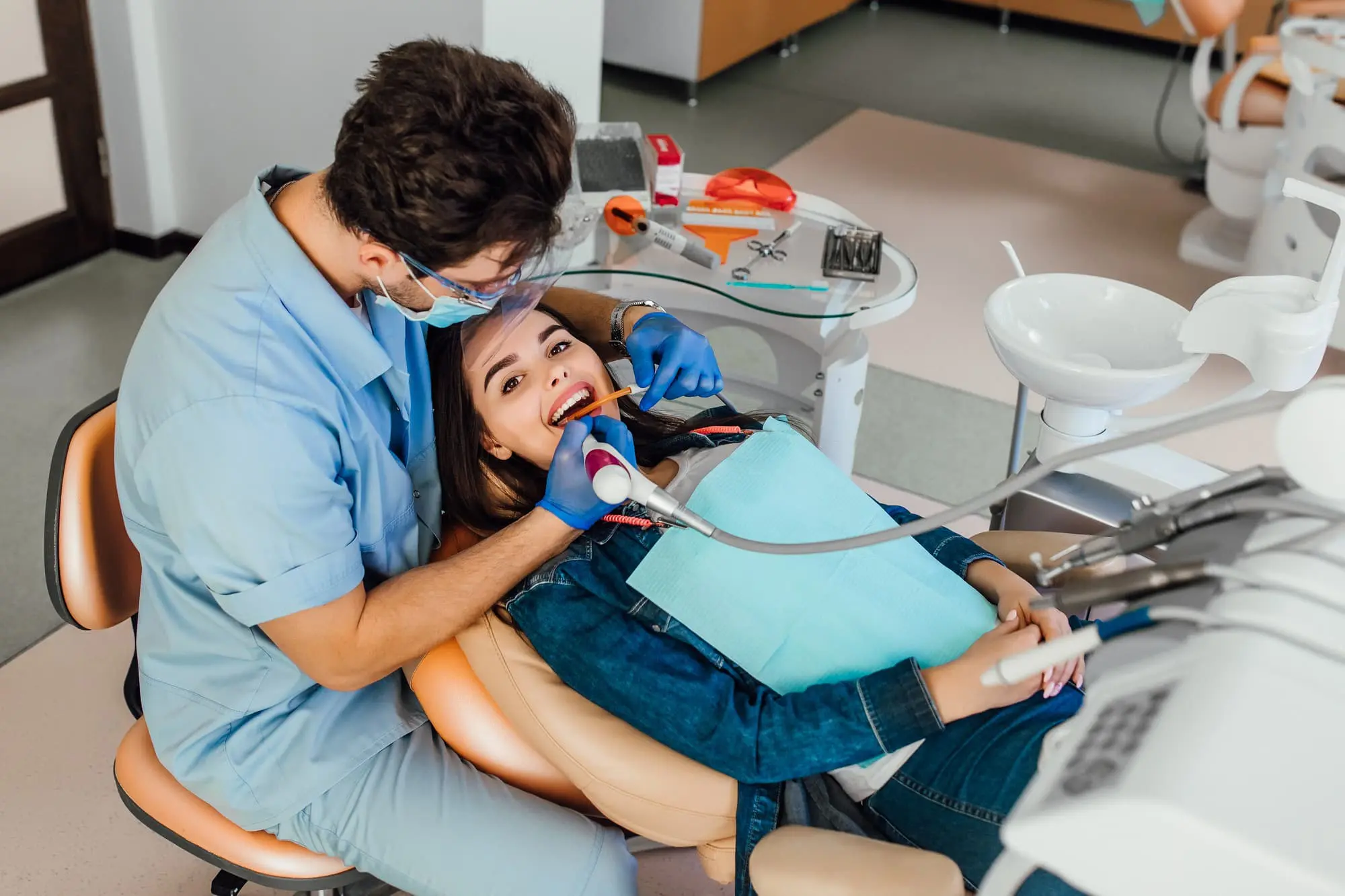At Gianquinto Orthodontic Arts in Mammoth Lakes, CA, a dentist examines a patient’s teeth; free orthodontic consultation for braces offered.