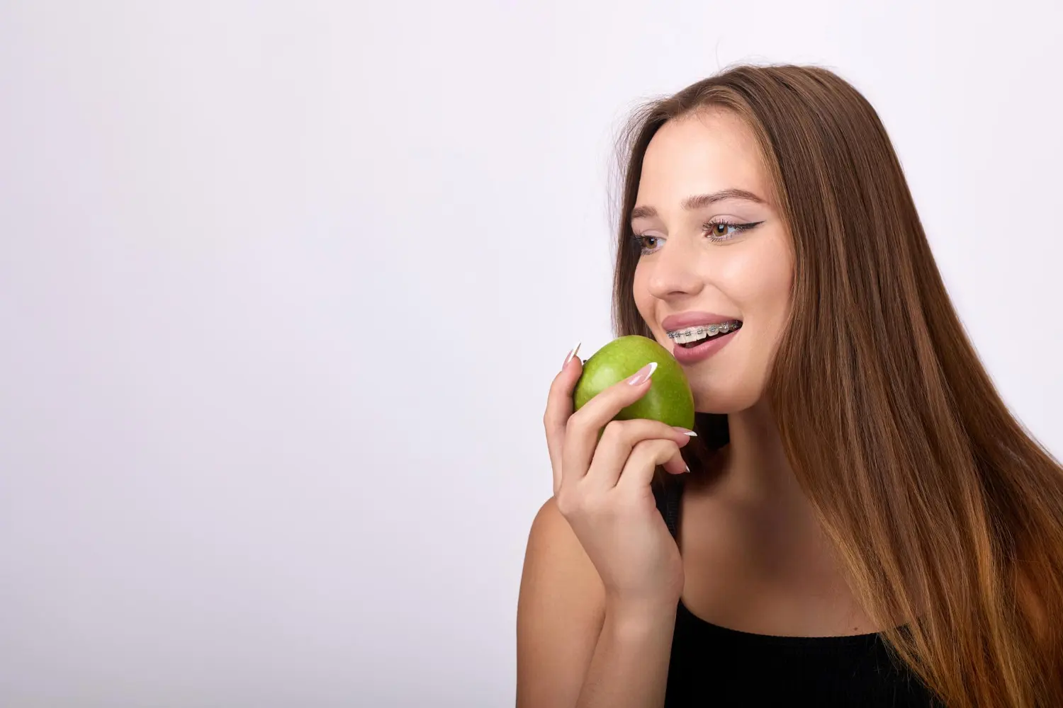 woman understanding the importance of smile aesthetics with adult braces from Gianquinto Orthodontic Arts in Bakersfield, Tehachapi or Mammoth Lakes, CA