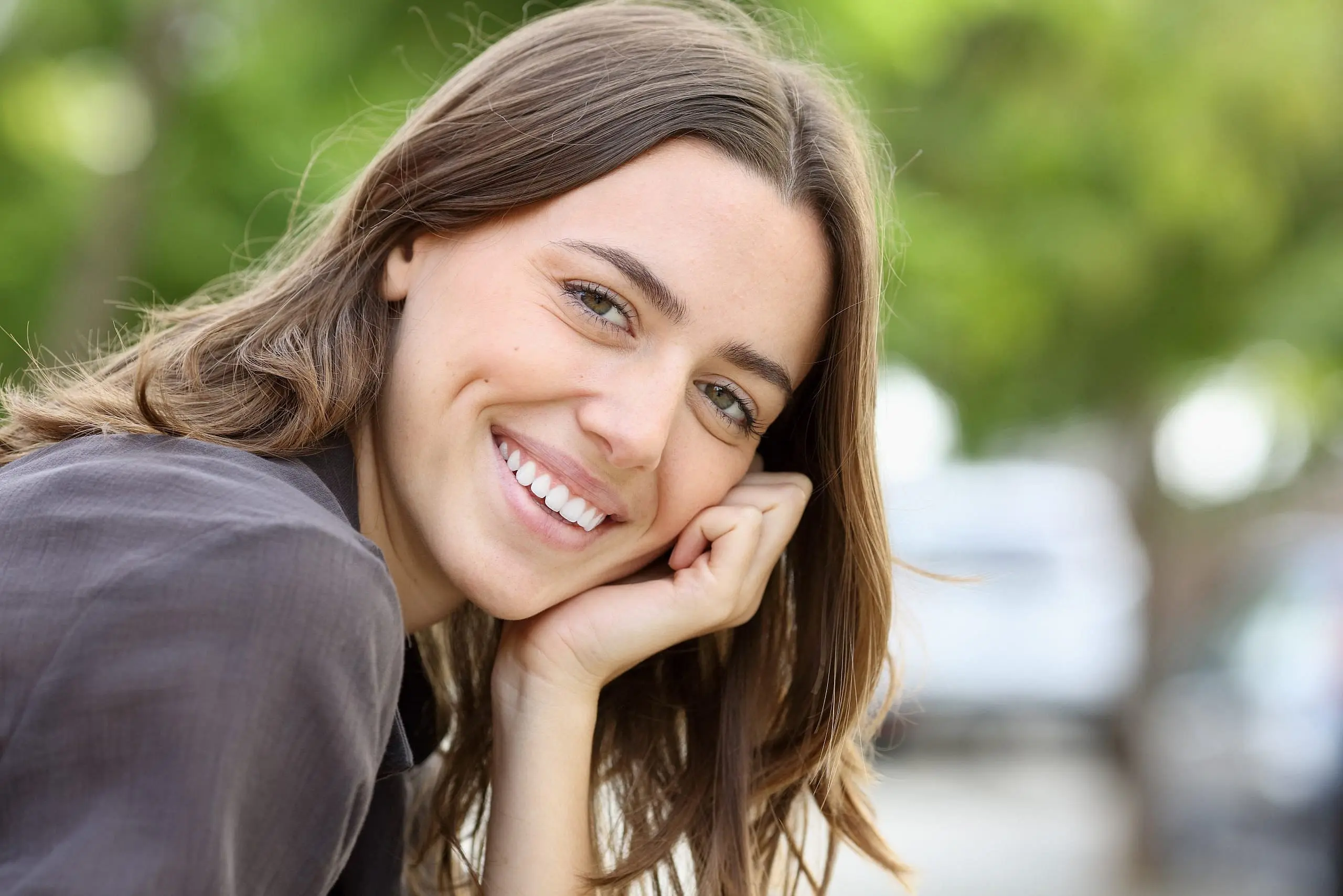 A young woman smiles considering Invisalign payment plans at Gianquinto Orthodontic Arts in Bakersfield, Tehachapi or Mammoth Lakes, CA