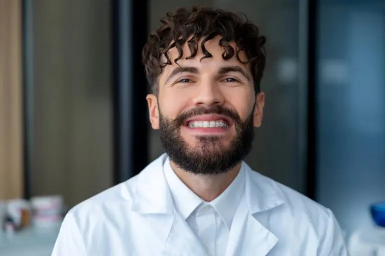 bearded man dentist clear braces showing importance dental care - How Long Does It Take To Get Used To Braces in Bakersfield, CA