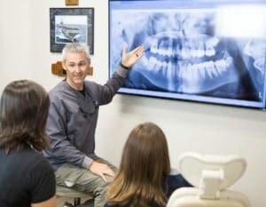 Dr. G showing an Xray to patients