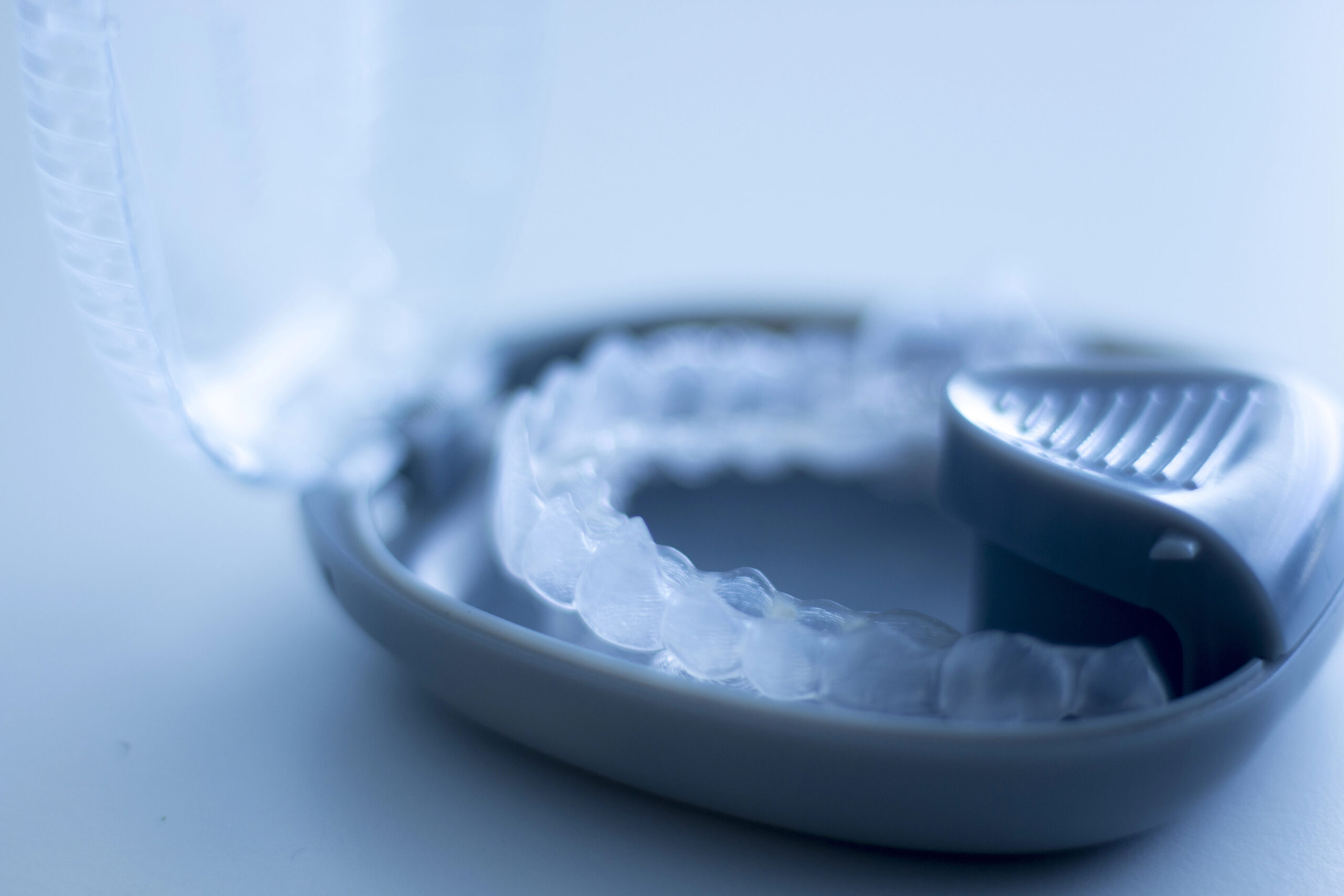 Close-up of Invisalign in a protective case, showcasing their transparent design and portability for orthodontic treatment.