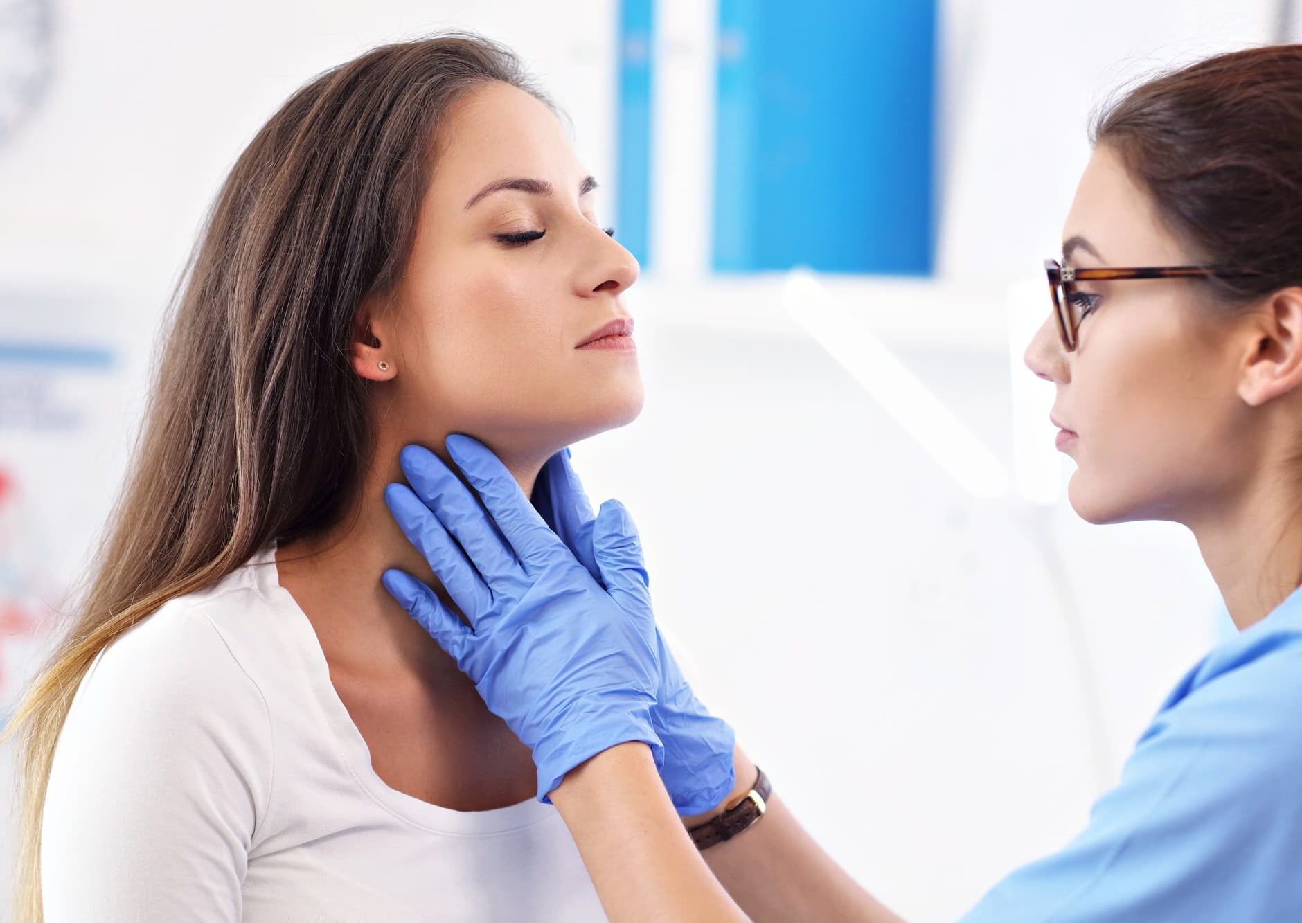A doctor examines a patient’s neck for Rehabilitation Exercises after jaw surgery at Gianquinto Orthodontic Arts in Bakersfield, Tehachapi or Mammoth Lakes, CA.