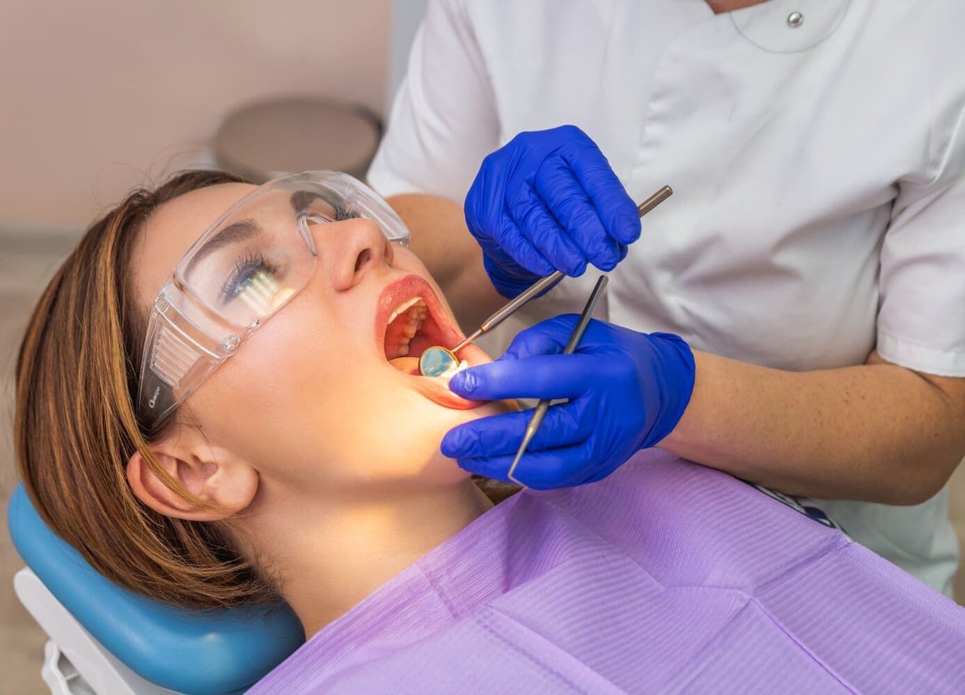 A dentist in blue gloves checks a patient’s underbite at Gianquinto Orthodontic Arts in Bakersfield, Tehachapi or Mammoth Lakes, CA